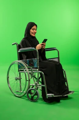 Saudi Woman in Wheelchair Using Phone on Green Screen