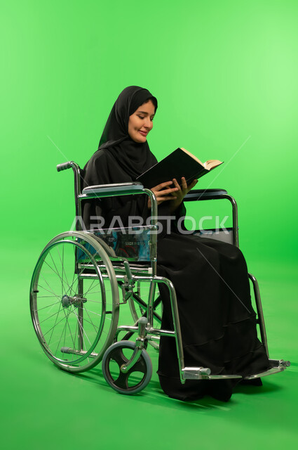 Saudi Woman in Wheelchair Reading Book on Green Screen