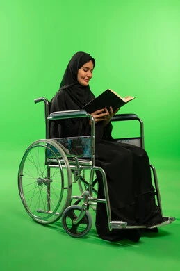 Saudi Woman in Wheelchair Reading Book on Green Screen