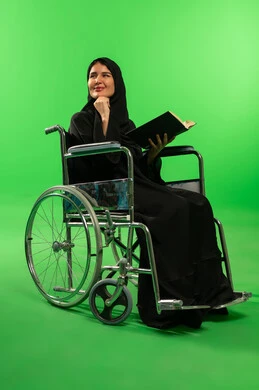 Saudi Woman in Wheelchair Reading on Green Screen