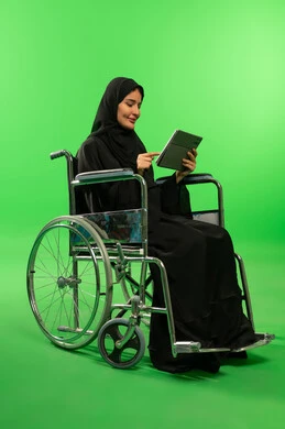 Saudi Woman in Wheelchair Using Tablet on Green Screen