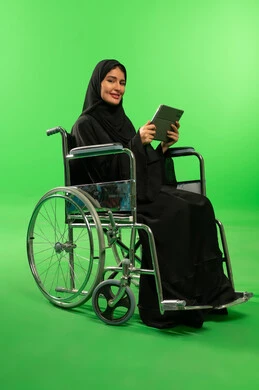 Saudi Woman in Wheelchair with Tablet on Green Screen