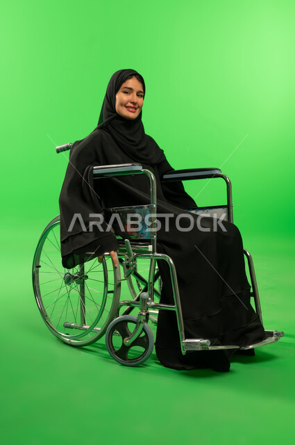 Saudi Woman in Wheelchair on Green Screen Background