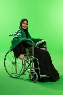 Saudi Woman in Wheelchair with National Flag