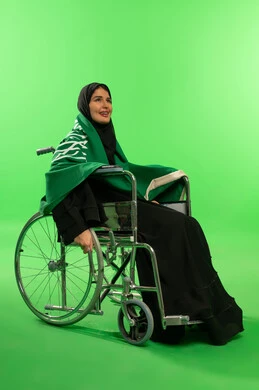 Saudi Woman in Wheelchair with Flag on Green Screen