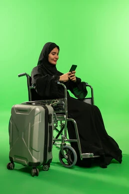 Saudi Woman in Wheelchair with Suitcase on Green Screen