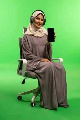Saudi Woman with Smartphone and Headphones on Green Screen
