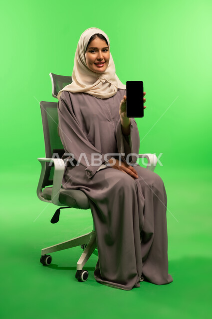 Saudi Woman Holding Smartphone on Green Screen