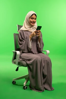 Saudi Woman in Abaya Using Smartphone on Green Screen