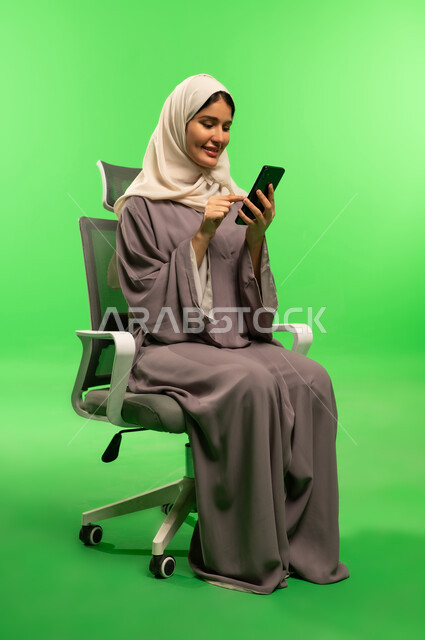 Saudi Woman Using Smartphone on Green Screen