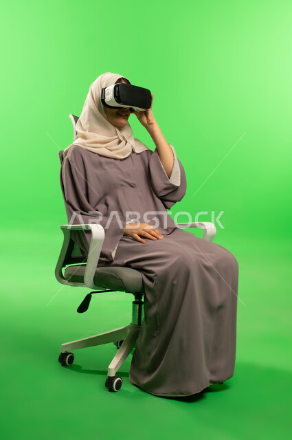 Saudi Woman with VR Headset on Green Screen Background