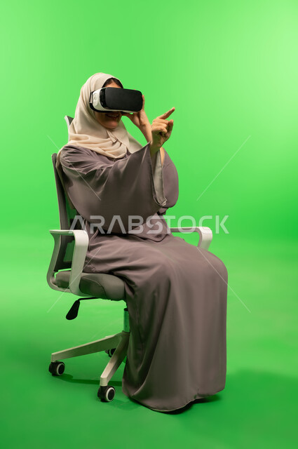 Saudi Woman Using VR Goggles on Green Screen