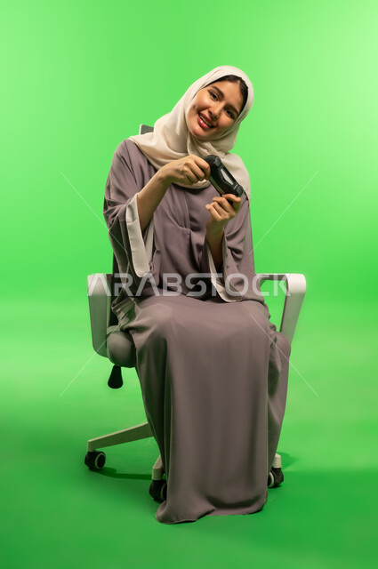 Saudi Woman with Gaming Controller on Green Screen