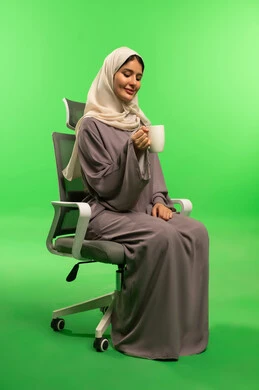 Saudi Woman with Coffee on Green Screen Office Chair
