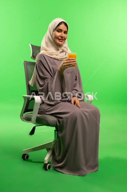 Saudi Woman with Juice on Green Screen Background