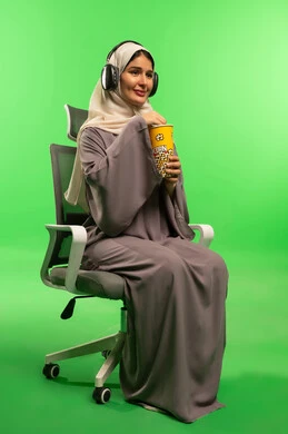 Saudi Woman with Headphones and Popcorn on Green Screen
