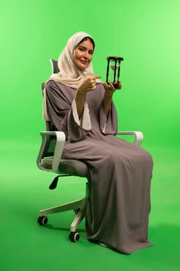 Saudi Woman with Hourglass on Green Screen Background