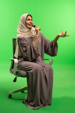 Saudi Woman with Microphone on Green Screen Background
