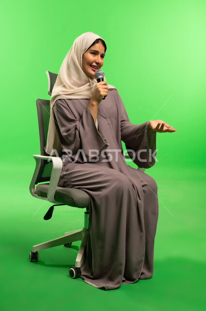 Saudi Woman with Microphone on Green Screen Background