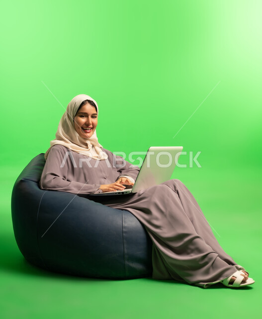 Saudi Woman with Laptop on Green Screen Background