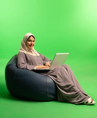 Saudi Woman Using Laptop on Green Screen