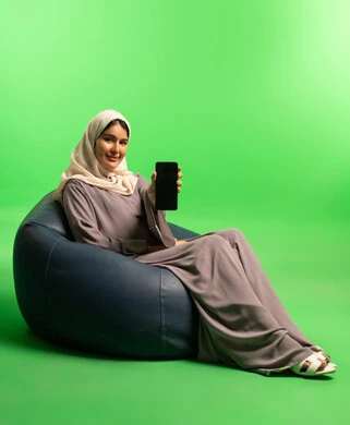 Saudi Woman Holding Smartphone on Green Screen Background