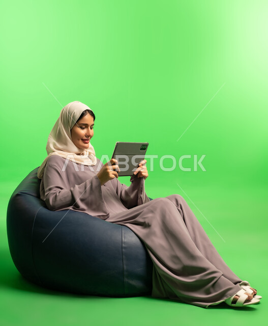 Saudi Woman with Tablet on Green Screen Background
