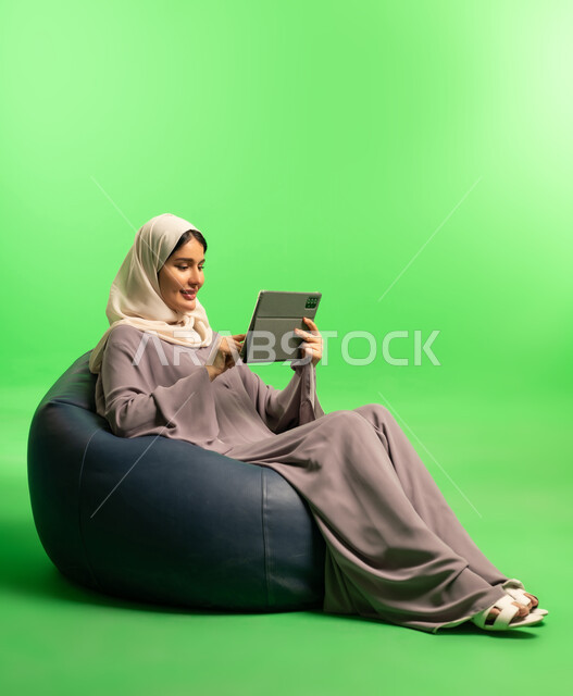 Saudi Woman Using Tablet on Green Screen Background