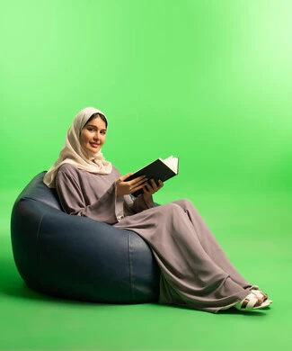 Saudi Woman Reading Book on Green Screen Background