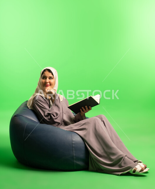 Saudi Woman Reading on Bean Bag Green Screen