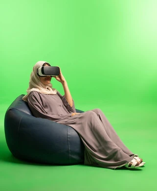 Saudi Woman Using VR Headset on Green Screen Background