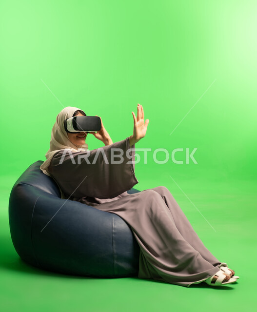 Saudi Woman Using VR Headset on Studio Green Screen