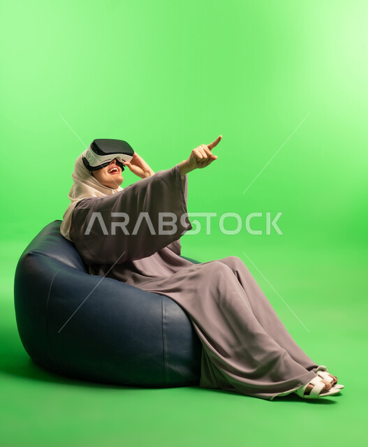 Saudi Woman Using VR Headset on Green Screen Background
