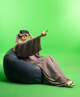 Saudi Woman Using VR Headset on Green Screen Background