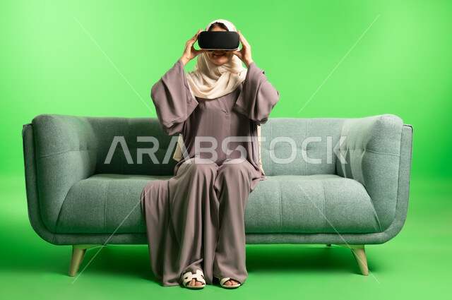 Saudi Woman Using VR Goggles on Green Screen