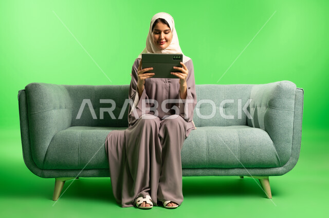 Saudi Woman with Tablet on Green Screen Background