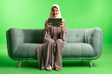 Saudi Woman with Tablet on Green Screen Background