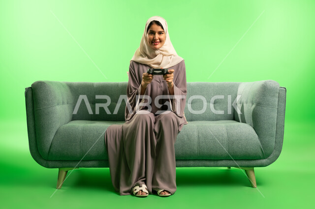 Saudi Woman with Gaming Controller on Green Screen