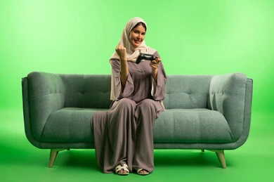 Saudi Woman Gaming with Controller on Green Screen