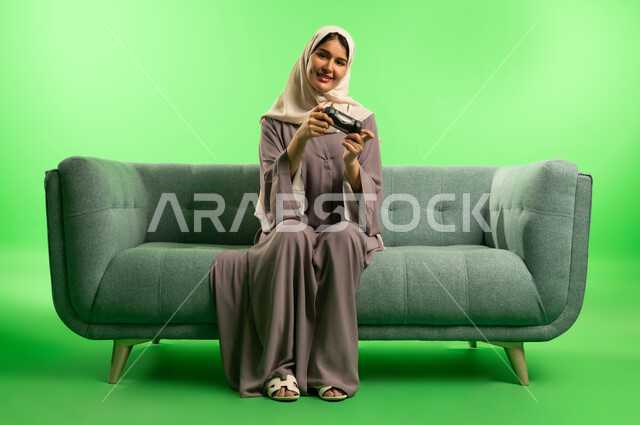 Saudi Woman Gaming on Sofa with Green Screen