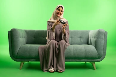 Saudi Woman Gaming on Sofa with Green Screen