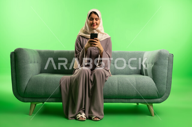 Saudi Woman Using Smartphone on Green Screen Background