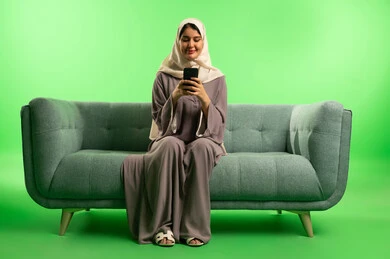 Saudi Woman Using Smartphone on Green Screen Background