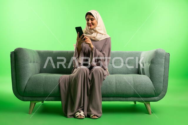 Saudi Woman Using Smartphone on Green Screen Background