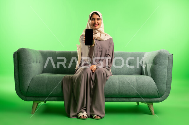 Saudi Woman Holding Smartphone on Green Screen