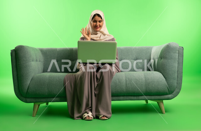 Saudi Woman Using Laptop on Green Screen Background