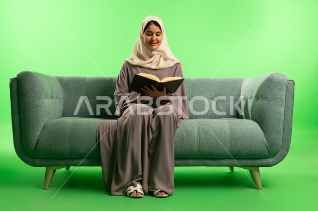 Saudi Woman Reading Book on Sofa Green Screen