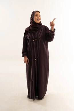 Saudi Woman in Abaya Pointing Up in Studio