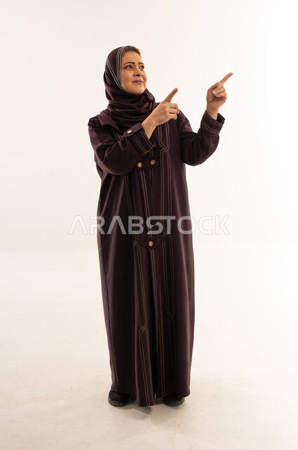 Saudi Woman in Abaya Pointing on White Background