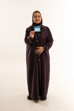 امرأة سعودية تحمل بطاقة تعريف فارغة في الاستوديو